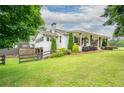 Side view of beautiful home featuring mature trees and well-kept lawn at 4067 Mason Creek Rd, Winston, GA 30187
