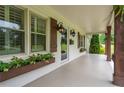 Inviting front porch featuring flower boxes, updated lighting, and wood columns at 4067 Mason Creek Rd, Winston, GA 30187