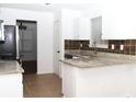 Bright kitchen featuring granite countertops, stainless steel appliances, and tile flooring for a modern touch at 1630 Versailles Dr, Atlanta, GA 30331