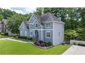 Stunning house with side entry garage, beautiful lawn, and stone retaining wall at 1634 Crittenden Ln, Lawrenceville, GA 30043