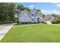 Well-maintained home featuring manicured lawn and mature landscaping at 1634 Crittenden Ln, Lawrenceville, GA 30043