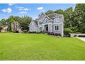 Lovely home with well-manicured lawn, mature trees, and a charming facade at 1634 Crittenden Ln, Lawrenceville, GA 30043