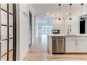 Open-concept view from the kitchen into the living space with a fireplace, showcasing modern design and seamless flow at 625 Piedmont Ne Ave # 2004, Atlanta, GA 30308