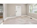 Bright living room with large window, tiled floors, and white door at 1396 Elizabeth Ln, Atlanta, GA 30344