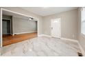 Bright living room featuring a ceiling fan, tiled floors, large window and an open floor plan at 1396 Elizabeth Ln, Atlanta, GA 30344