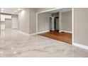 Open concept living room with tile flooring connecting to an updated kitchen at 1396 Elizabeth Ln, Atlanta, GA 30344