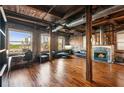 Spacious living room with exposed brick walls, hardwood floors, fireplace, and large windows at 490 Marietta St Nw # 307, Atlanta, GA 30313
