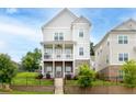 Charming home featuring a brick foundation, two-story porch, and landscaped front yard at 831 Corsiglia Farm Flts, Marietta, GA 30060
