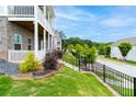 Landscaped exterior featuring a black metal fence and stairs leading to the home's entrance at 831 Corsiglia Farm Flts, Marietta, GA 30060