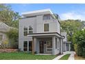 Contemporary two-story house with a rooftop deck, gray siding, and manicured front yard at 1186A Francis Nw St, Atlanta, GA 30318