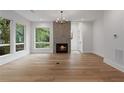 Spacious living room featuring hardwood floors, fireplace, and large windows with a view at 1186B Francis Nw St, Atlanta, GA 30318