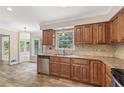 Eat-in kitchen with wood cabinets, granite counters, stainless steel dishwasher and tiled backsplash at 4179 Westchester Ne Xing, Roswell, GA 30075