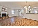 Bright living room with beautiful laminate floors, fireplace, and an opening into the updated kitchen at 6035 Wintergreen Rd, Norcross, GA 30093