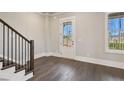 Bright entryway featuring hardwood floors, staircase, and glass paneled exterior door at 95 Old Town Rd, Dacula, GA 30019