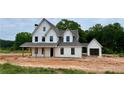 New construction home with white siding, black trim, and welcoming front porch at 95 Old Town Rd, Dacula, GA 30019