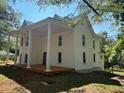 Two-story home featuring a large front porch supported by stately columns at 119 E Johnson St, Temple, GA 30179