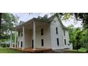 Two-story home featuring a large front porch supported by stately columns at 119 E Johnson St, Temple, GA 30179