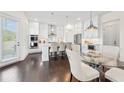 Modern kitchen featuring white cabinets, stainless steel appliances, and a glass top table at 3330 Carswell Bnd, Cumming, GA 30028
