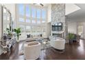 Bright living room featuring a stone fireplace and a wall of beautiful windows at 3330 Carswell Bnd, Cumming, GA 30028