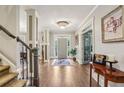 Spacious foyer with hardwood floors, elegant staircase, and classic decor, creating a grand entrance at 3665 Pennington Rd, Cumming, GA 30041