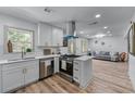 Modern kitchen with stainless steel appliances, a breakfast bar and open to the living room at 1819 Waldrep Se Cir, Marietta, GA 30060