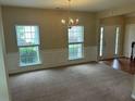 Bright open living room featuring carpet, windows, decorative molding, and front entry at 3140 Tylerton Sw Dr, Atlanta, GA 30311
