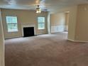 Bright open living room featuring carpet, a fireplace, and access to other rooms at 3140 Tylerton Sw Dr, Atlanta, GA 30311