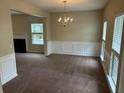 Bright living room featuring carpet, windows, decorative molding and an elegant chandelier at 3140 Tylerton Sw Dr, Atlanta, GA 30311