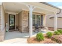 Charming front porch with chairs and decorative plants at 3397 Long Creek Drive, Buford, GA 30519