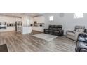 Open-concept living room flows into a modern kitchen with stainless steel appliances and a large island at 3397 Long Creek Drive, Buford, GA 30519