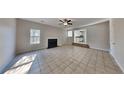 Spacious living room with tile flooring, a fireplace, and an open layout to the kitchen at 4688 Snap Creek Ln, Decatur, GA 30035