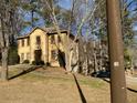 Home featuring a well-maintained lawn and mature trees surrounding the property at 7592 Watson Kaye, Stone Mountain, GA 30087
