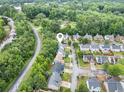 Aerial view of a suburban neighborhood with lush green trees surrounding the homes at 4188 Cookcreek Place Northwest Nw Pl, Lilburn, GA 30047