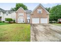 Charming brick home with a well-manicured lawn and a two-car garage at 4188 Cookcreek Place Northwest Nw Pl, Lilburn, GA 30047