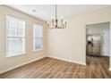 The dining room boasts wood floors, neutral walls, and stainless steel appliances in the adjacent kitchen at 4593 Parkway Cir, Atlanta, GA 30349