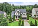 A stunning two-story brick home showcasing lush landscaping and a spacious driveway at 7060 Summit Ridge Chase, Cumming, GA 30041