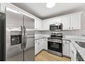 Modern kitchen with stainless steel appliances, granite counters, and subway tile backsplash at 89 Prospect Path, Hiram, GA 30141
