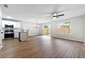 Sun-filled living space with laminate floors, ceiling fan, and an updated kitchen, perfect for gatherings at 89 Prospect Path, Hiram, GA 30141