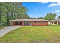 Charming single-story brick home with a spacious front yard and attached carport at 191 Pine Ne St, Fairburn, GA 30213