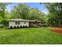 Beautiful single story home featuring a well-manicured lawn and charming curb appeal surrounded by mature trees at 2020 New Kemp Rd, Marietta, GA 30066