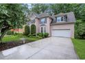 Exterior view of this beautiful stucco home with a wide driveway and well-maintained landscaping at 11280 Brookhollow Trl, Alpharetta, GA 30022