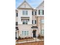 Well-maintained townhome displays a classic light brick and siding facade with black shutters at 3322 Cranston Ln, Kennesaw, GA 30144