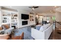 Bright living room boasts a stone fireplace, custom built-ins and hardwood floors at 4104 Townsend Ln, Dunwoody, GA 30346