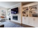 Living room boasts a fireplace, built-in shelving, hardwood floors, and large windows at 4104 Townsend Ln, Dunwoody, GA 30346