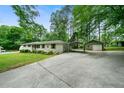 Exterior view of a one-story home with a carport and a detached garage at 5839 Darry Cir, Norcross, GA 30093