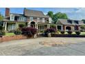 Beautiful home featuring a brick and stone circular driveway and a manicured landscape at 1695 Whitley Rd, Dacula, GA 30019