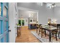 Inviting dining area with wood floors, seamlessly connected to an open-concept kitchen with a breakfast bar at 3726 Scotts Mill Run, Peachtree Corners, GA 30096