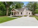 Attractive home with a well-maintained lawn and a long, modern concrete driveway at 1036 Dell Se Ave, Smyrna, GA 30080