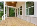 Inviting covered porch with wood flooring, offering a cozy outdoor space at 1036 Dell Se Ave, Smyrna, GA 30080