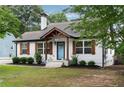 Charming home with a well-maintained lawn, stone pathway, and a delightful blue front door at 3412 Orchard St, Atlanta, GA 30354